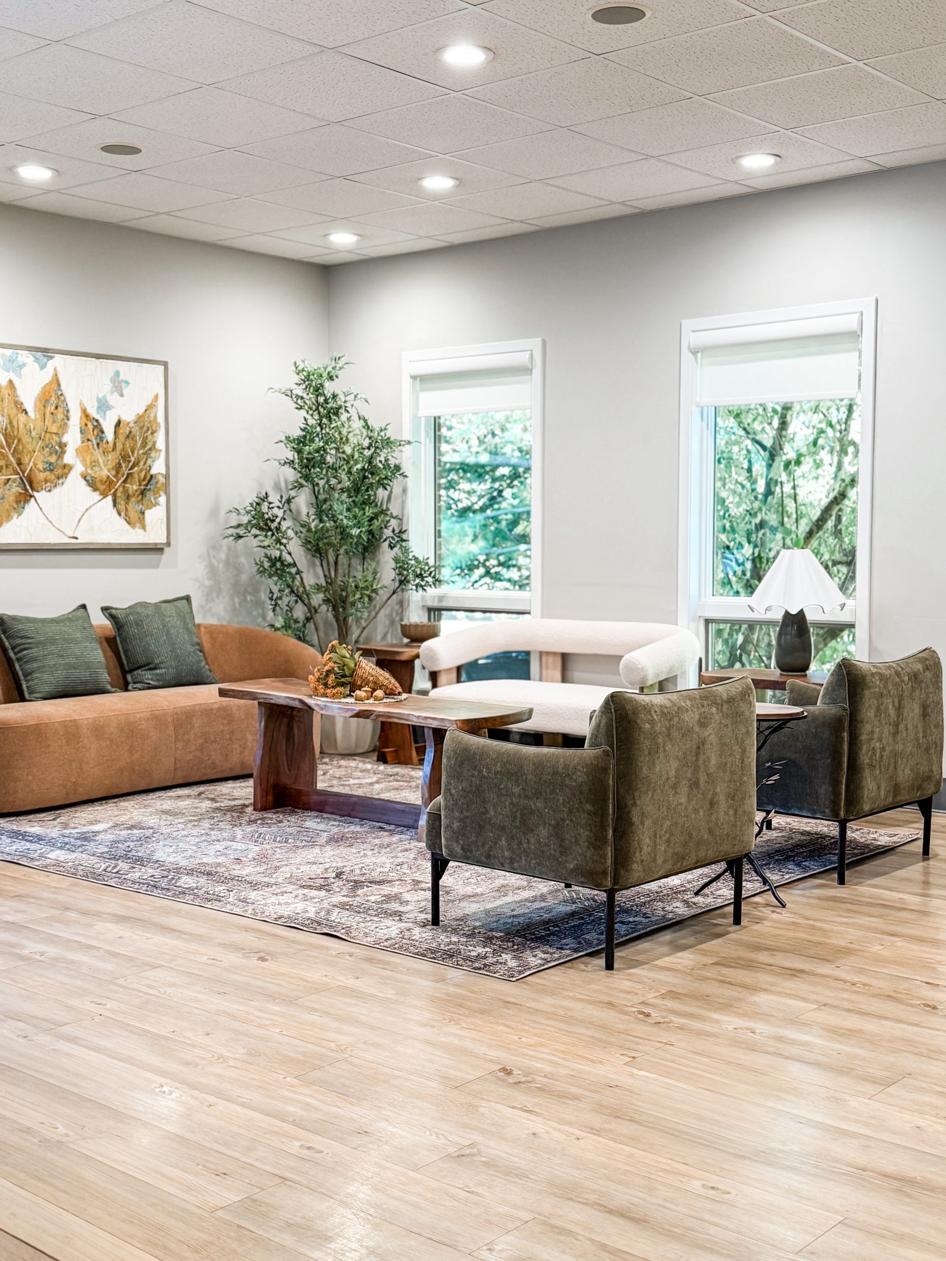 Wide-angle view of the dental office waiting room featuring modern chairs and a couch, creating a comfortable and welcoming patient environment.